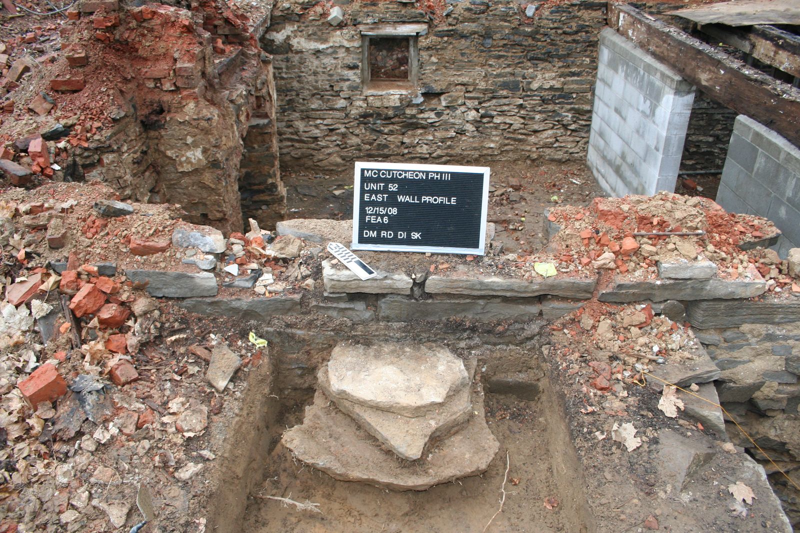 Excavated stone foundation feature with a photo board