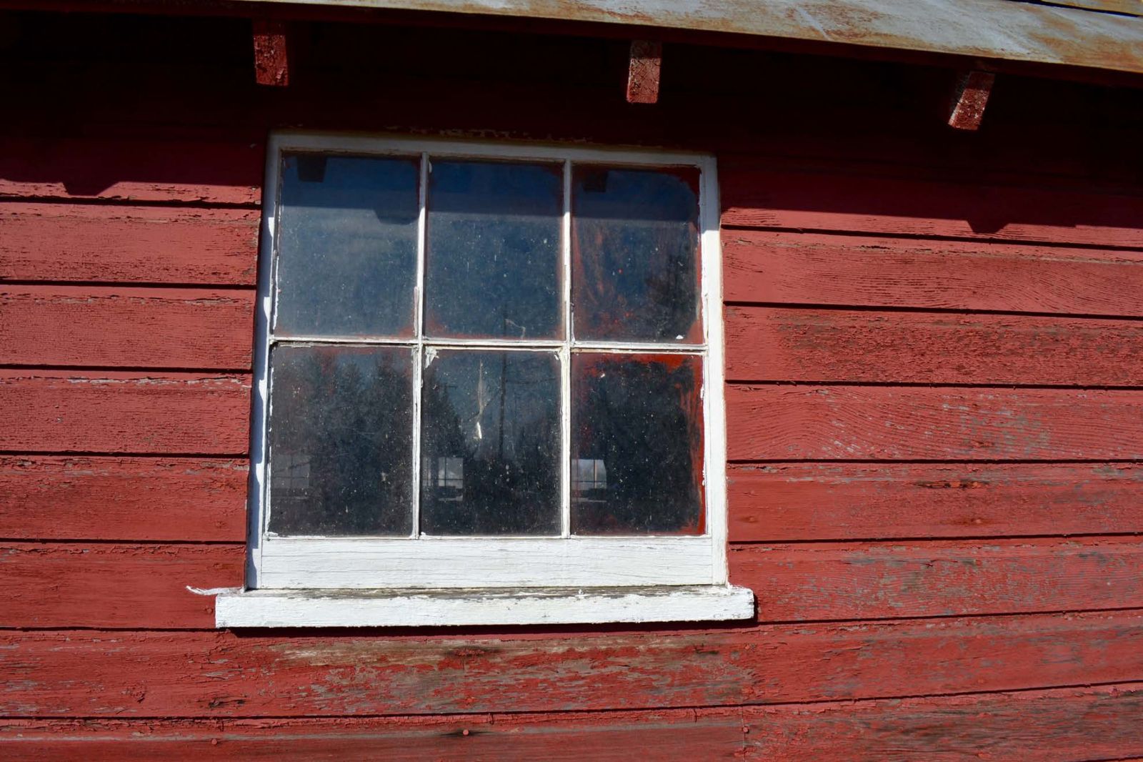 Six-light wooden sash window typical of the main barn.