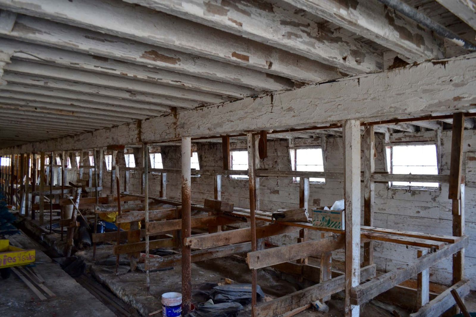 First floor of the main barn with steel-pipe and wood stanchions.